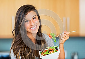 Healthy woman eating salad