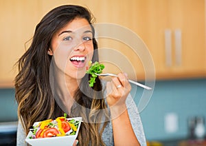 Healthy woman eating salad photo