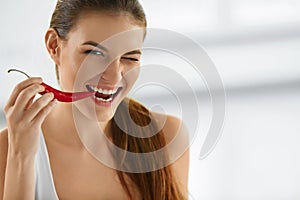Healthy Woman Eating Spicy Red Chili Pepper. Diet, Food Concept.