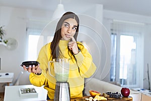 Healthy woman enjoy making green vegetables detox cleanse and green fruit smoothie with blender in kitchen at home. Healthy