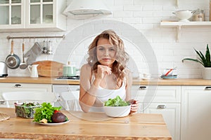 Healthy woman in the home kitchen. Healthy lifestyle and vegetarian diet concept
