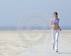 Healthy woman jogging at the beach