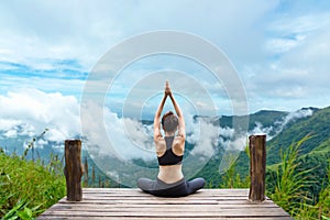 Healthy woman lifestyle balanced practicing meditate and zen energy yoga on the bridge in morning the mountain nature photo