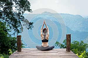 Healthy woman lifestyle balanced practicing meditate and zen energy yoga outdoors on the bridge in morning the mountain nature