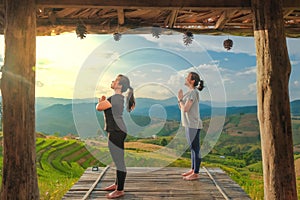 Healthy woman lifestyle balanced practicing meditate and zen energy yoga outdoors on the bridge in morning the mountain nature.