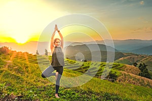 Healthy woman lifestyle balanced practicing meditate and zen energy yoga outdoors on the bridge in morning the mountain nature.