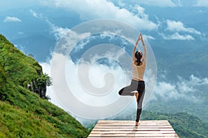 Healthy woman lifestyle exercising vital meditate and practicing yoga at the bridge in morning the mountain,