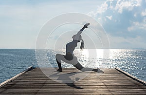 Healthy woman lifestyle exercising vital meditate and practicing yoga at seashore, nature background.