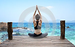 Healthy woman lifestyle exercising vital meditate and practicing yoga at seashore, nature background