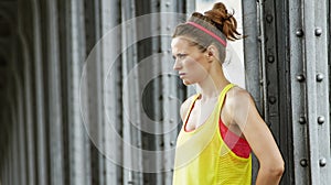 Healthy woman looking into distance on Pont de Bir-Hakeim bridge