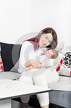 Healthy Woman and New Born Boy Relax in White Bedroom or Living