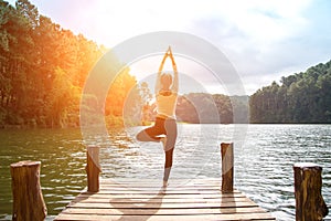 Healthy woman practicing yoga on the bridge