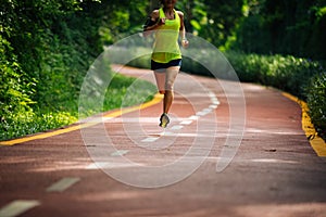 Woman runner running on morning park road workout jogging