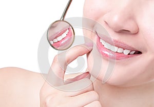 Healthy woman teeth and a dentist mouth mirror