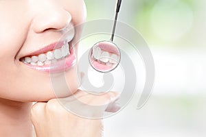 Healthy woman teeth and dentist mouth mirror