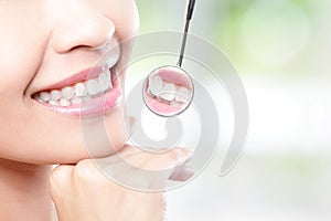 Healthy woman teeth and dentist mouth mirror photo