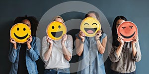 Healthy workplace culture concept. A group of diverse people holding happy emoticons. Teamwork