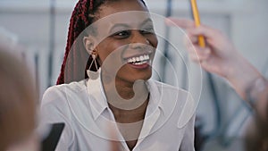 Healthy workplace, portrait of young smiling professional black business woman speaking to colleagues at work meeting.