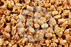 Healthy yellow organic granola breakfast flakes texture close up