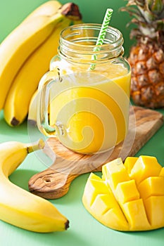 Healthy yellow smoothie with mango pineapple banana in mason jar