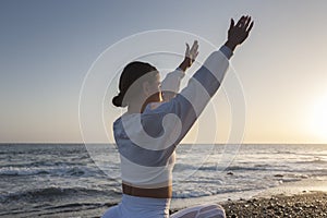 Healthy with Yoga Concept. Attractive young woman practice Warrior Pose Virabhadrasana in Yoga on sunset