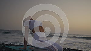 Healthy with Yoga Concept. Attractive young woman practice yoga on the beach during sunset.