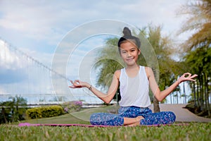 Healthy yoga girls and concentrate in the park , kid Yoga Practice for Health in the nice day , yoga kid