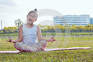 Healthy yoga girls and concentrate in the park , kid Yoga Practice for Health in the nice day , yoga kid