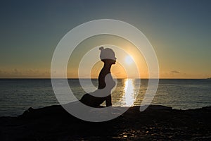 Healthy yoga woman meditation at sunrise seaside photo