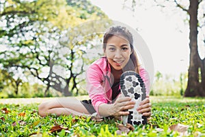 Healthy young asian woman exercising at park. Fit young woman doing training workout in morning.