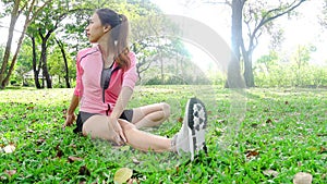 Healthy young asian woman exercising at park. Fit young woman doing training workout in morning.