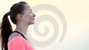 Healthy, young beautiful woman meditating, practicing yoga among the sand, on the beach, by the sea, river, at dawn, at