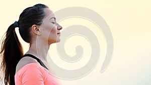 Healthy, young beautiful woman meditating, practicing yoga among the sand, on the beach, by the sea, river, at dawn, at