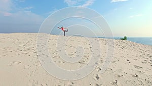 Healthy, young beautiful woman in sunglasses meditating, stretching, practicing yoga on the sea beach, at sunrise, Makes