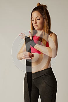 Healthy young female boxer wearing strap