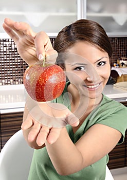 Healthy young female holding a fresh ripe apple