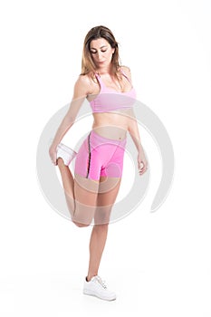 Healthy young fitness personal trainer woman warm up before sport training. Active lifestyle female isolated on white.