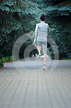 Healthy young fitness woman trail runner running at the park. Ba