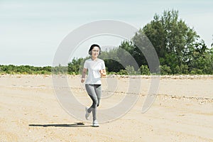 Healthy young fitness woman trail runner running  Sports fitness run on the beach near the sea