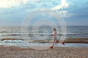 Healthy young fitness woman trail runner running on sunrise seaside