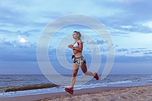 Healthy young fitness woman trail runner running on sunrise seaside