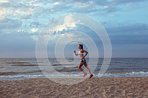 Healthy young fitness woman trail runner running on sunrise seaside