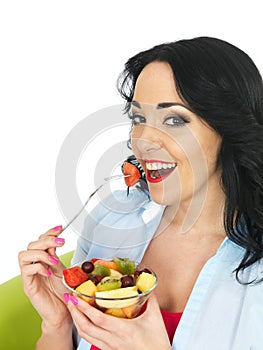 Healthy Young Fresh Faced Woman Eating a Colourful Exotic Fresh Fruit Salad