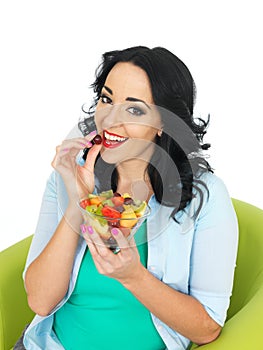Healthy Young Fresh Faced Woman Holding a Fresh Bowl of Mixed Exotic Fruit Salad