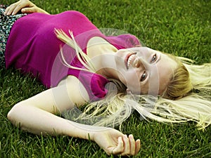 Healthy young girl laying on the grass
