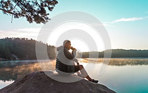 healthy young man drink coffee in height mountain at early morning and sunrise. beautiful nature. Lake and mountains