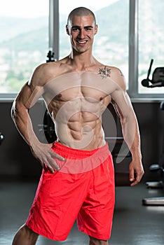 Healthy Young Man Flexing Muscles