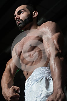 Healthy Young Man Flexing Muscles