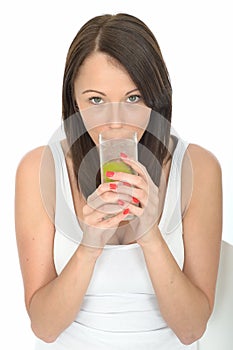 Healthy Young Natural Woman Drinking a Glass of Iced Water with Slice of Lime