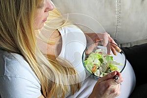 Healthy Young Pregnant Woman Eating a Green Leaf Salad